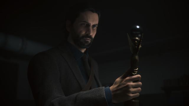 Alan Wake holds the angel lamp