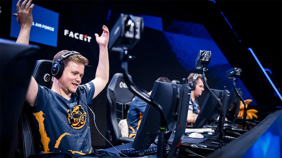 Snappi, a CS2 player for ENCE, raises his hands on-stage while playing at IEM Sydney 2023.